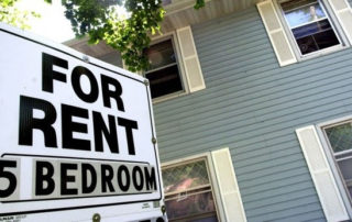 Older home with for rent sign in front featuring "5 bedrooms"