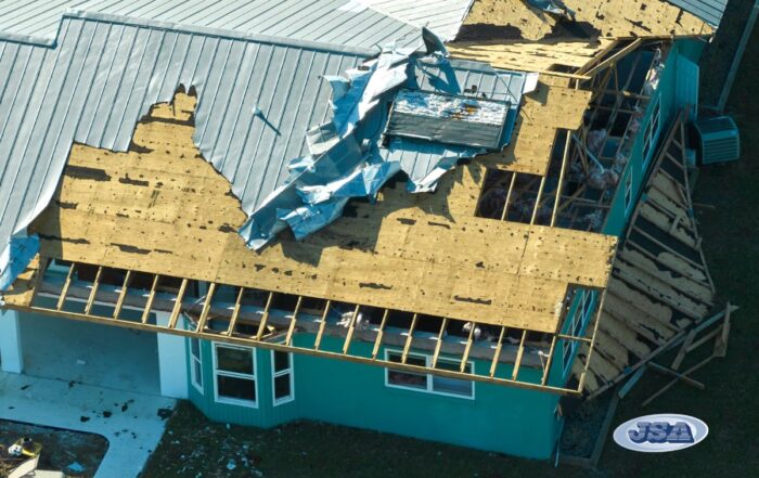 Partially-covered roof with wind damage